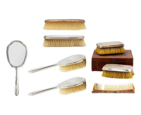 Two George V silver grooming sets in original boxes by Bravington Ltd. Including one box with two brushes and a broken comb, 