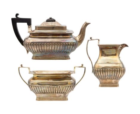 A Victorian silver three-piece tea set retailed by Watherston London. Of oblong half fluted form, with reeded edges, sponsors