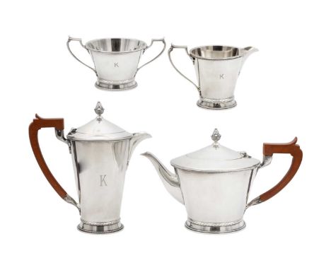 An Art Deco silver four-piece tea and coffee set by Mappin & Webb. Of a tapering shape with a beaded rim and base, leaf cast 