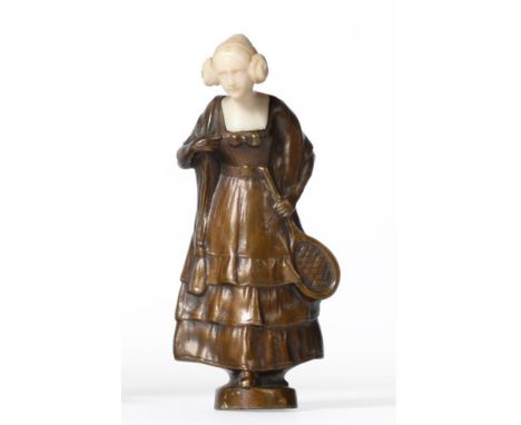 Ferdinand Lugerth (Austrian, fl. 1885-1915): A Bronze and Ivory Figure, modelled as a young woman holding a tennis racket/rac