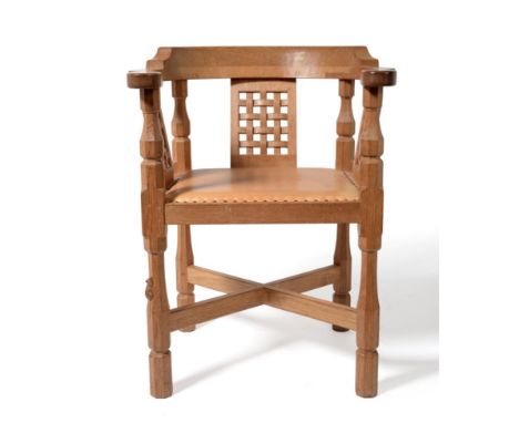 A Robert ''Mouseman'' Thompson Oak Monk's Chair, with curved back and shaped arms, over three lattice panels, on four octagon