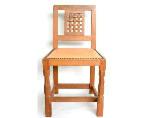 A Robert ''Mouseman'' Thompson Oak Lattice Back Dining Chair, with cow hide upholstered seat, on two octagonal turned front l