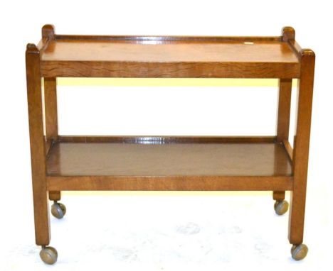 A Robert ''Mouseman'' Thompson Oak Tea Trolley, with two tiers both with raised sides joined by four square section legs, on 