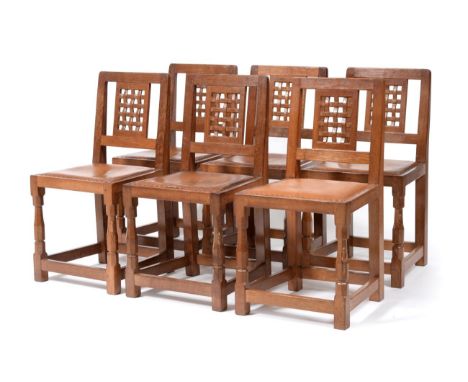 A Set of Six Robert ''Mouseman'' Thompson Oak Lattice Back Dining Chairs, with cow hide upholstered seats, on two octagonal f