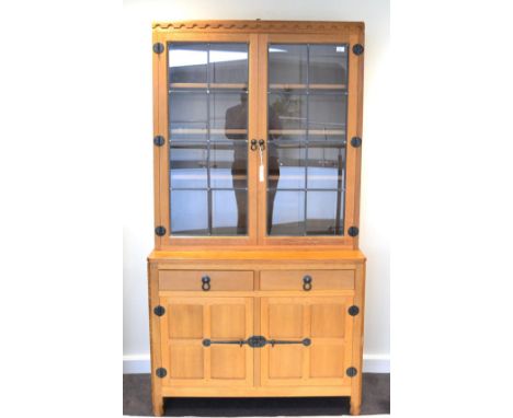 A Robert ''Mouseman'' Thompson Oak Bespoke Display Cupboard, the glazed upper section with three oak shelves, the double door