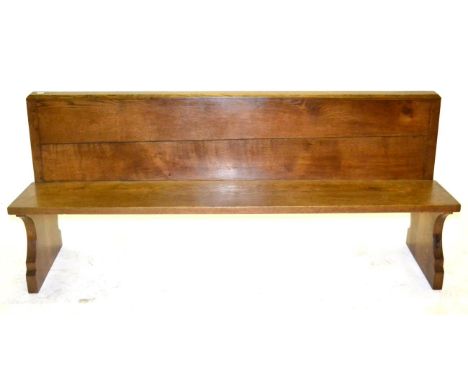 A Robert ''Mouseman'' Thompson Oak 6ft 1'' Pew, with book rest, on two shaped supports, with carved mouse signature, 185.5cm 