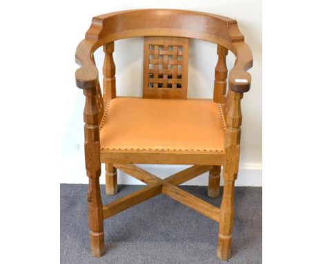 A Robert ''Mouseman'' Thompson Oak Monk's Chair, with curved back and shaped arms, over three lattice panels, on four octagon