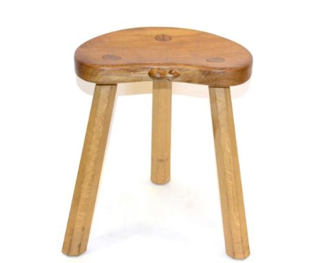 A Robert ''Mouseman'' Thompson Oak Calf Stool, on three octagonal legs, with carved mouse signature, 35.5cm; and A Robert ''M