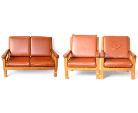 A Horace ''Knightman'' Knight Oak Three Piece Suite, comprising Two-Seater Sofa, with lattice back and side panels, with four