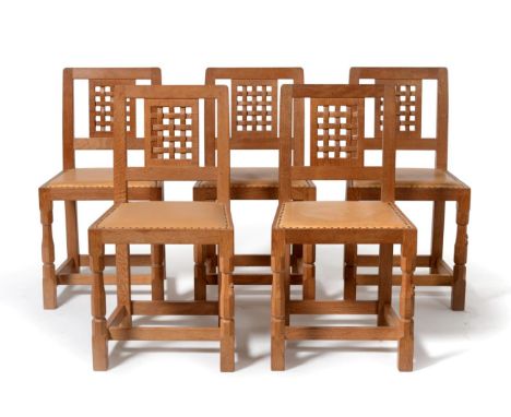 A Set of Five Robert ''Mouseman'' Thompson Oak Lattice Back Dining Chairs, on two octagonal front legs, each with carved mous