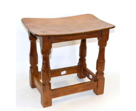 A Robert ''Mouseman'' Thompson Oak Dish Top Stool, on four octagonal legs joined by stretchers, with carved mouse signature, 