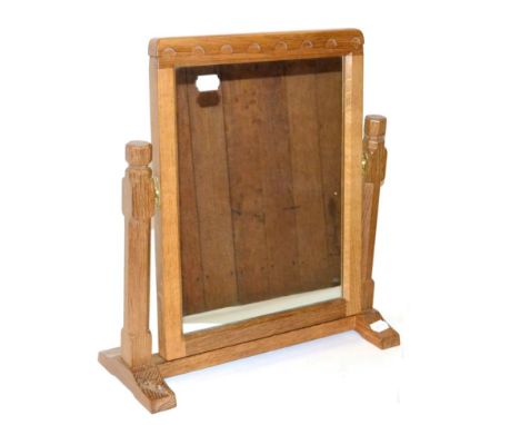 A Robert ''Mouseman'' Thompson Oak Stand Mirror, the rectangular mirror pivots between two octagonal supports on a low level 