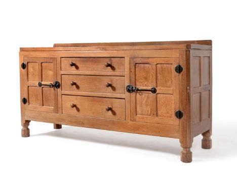 A Robert ''Mouseman'' Thompson Panelled Oak 5ft Sideboard, with raised upstand, above three graduating drawers, enclosed by t