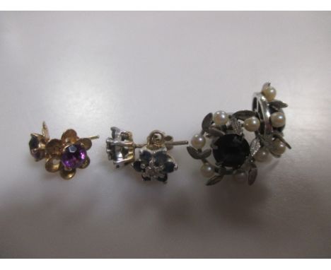 Three pairs of stone set earstuds, comprising a sapphire and diamond cluster, an amethyst set flower and an amethyst and pear