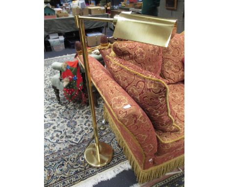 A modern brass floor standing reading lamp  