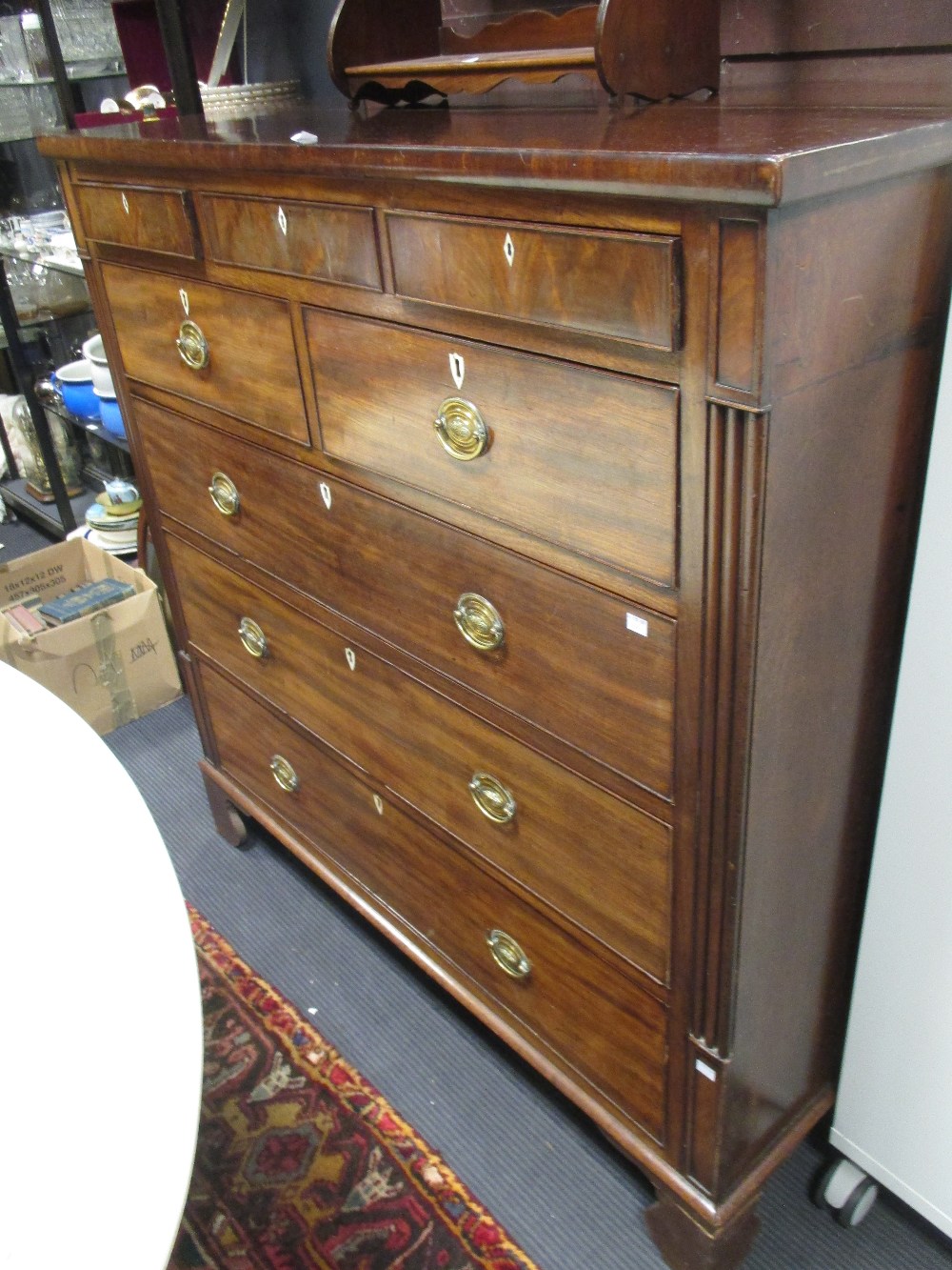 A late Regency North country mahogany chest of three small frieze drawers over four long