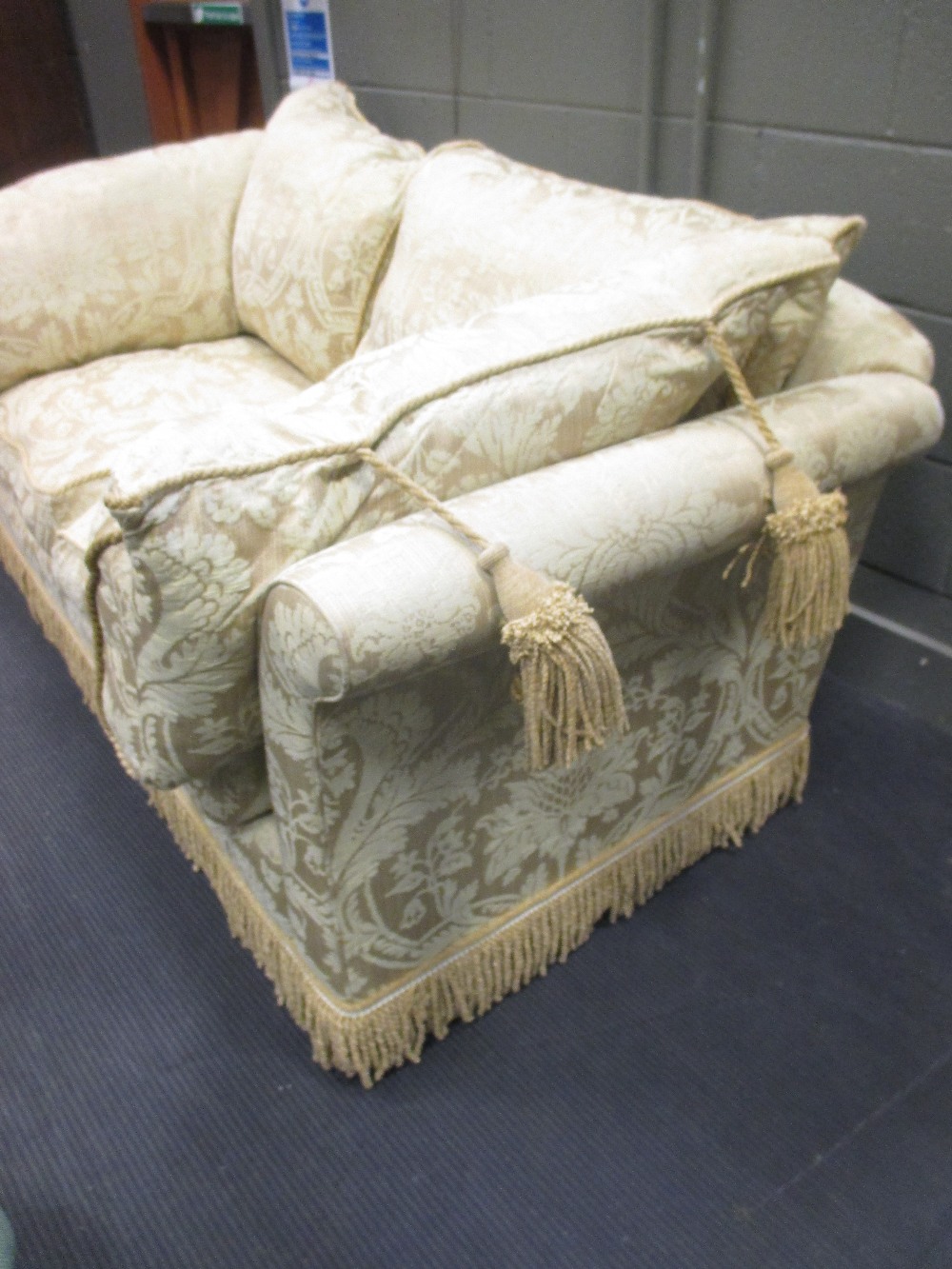 A two seater sofa in gold damask fabric with bullion fringe 200cm wide