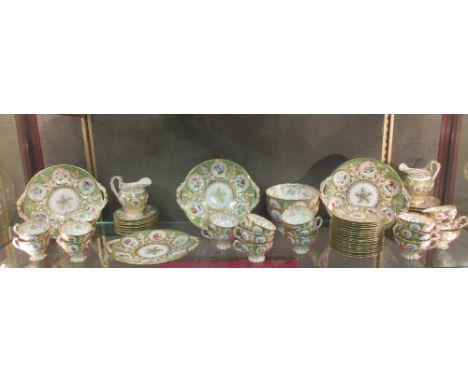 A 19th century English porcelain tea and coffee service comprising two jugs, two slop basins, thirty-seven saucers, fourteen 