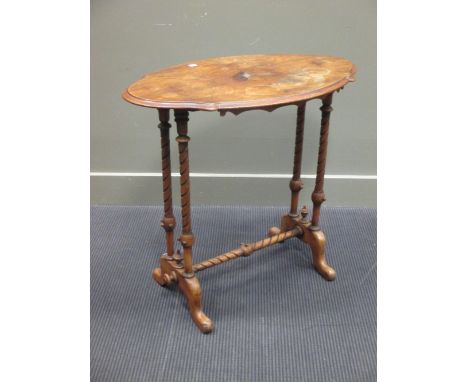 A Victorian walnut oval table on turned legs and outswept feet, and an oak framed firescreen with needlework panel for Clare 