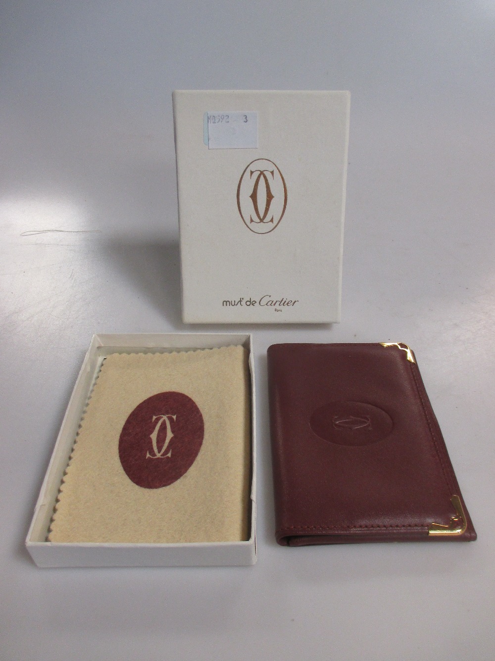 Cartier A burgundy leather credit card wallet complete with