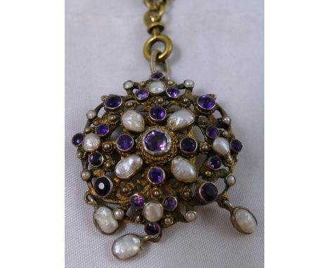 A late 19th century Austro-Hungarian silver, amethyst and baroque pearl brooch/pendant, bearing control marks, of openwork cl