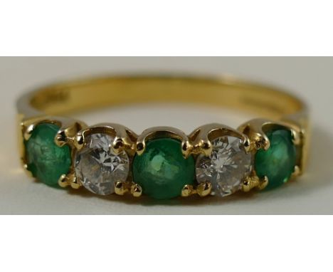 An 18ct gold emerald and diamond five stone ring, claw set with brilliant cut stones, size P.