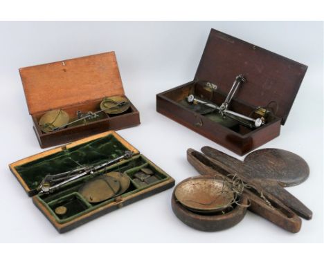 Four 19th century boxed sets of travelling balance scales, with steel beams and brass or steel pans, including a George III e