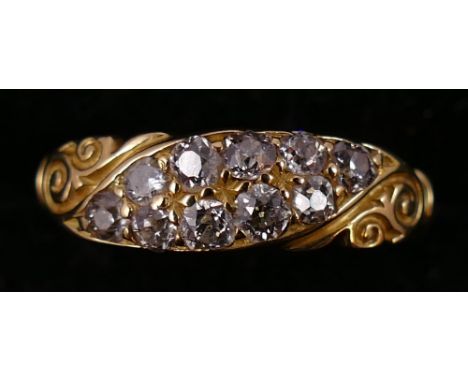 A Victorian 18ct gold and diamond boat shape ring, set with two rows of old cut stones, shank replaced and stamped 750, size 