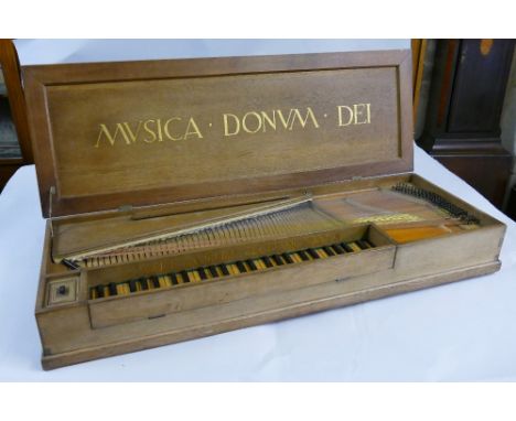 An Arts and Crafts style oak cased table top spinette, inscribed "Herbert Lambert Fecit MCMXXVIII", of oblong form, the insid