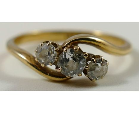 An 18ct gold three stone diamond ring, claw set with graduated old cut stones, total weight approximately 0.40cts, size N 1/2