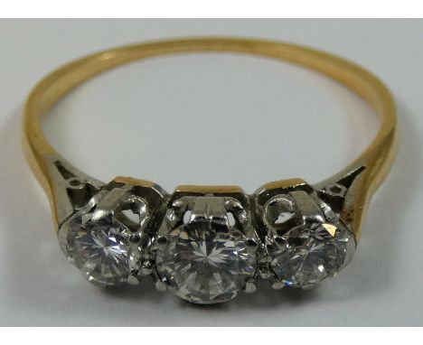 An 18ct gold three stone diamond ring, claw set with graduated brilliant cut stones, total weight approximately 1.0cts, size 