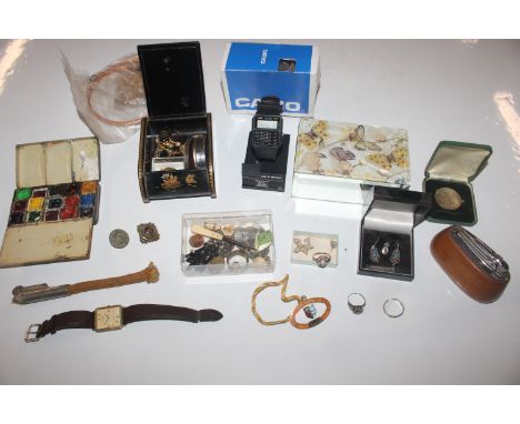 A box containing coinage, jewellery, Casio wrist watch, artist box etc.