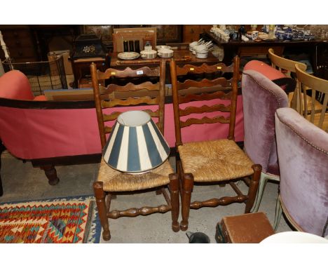 A pair of ladder back and rush seated dining chairs AF together with two lamp shades