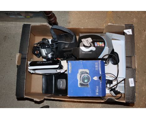 A box containing an Olympus SP-800 UZ; one other camcorder ; a Blaupunkt dash-cam; and a Konica Minolta digital camera