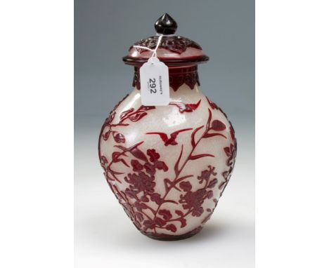 A Chinese Peking cased and carved baluster vase and cover, the ruby glass overlay carved with roosting birds and flowering sh