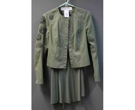 Christian Dior, a lady's three piece suit in olive green jersey, skirt and top with gathered detail, together with an embroid