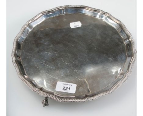 A silver salver, circular with raised tongue and groove border, on three ball and claw feet, Sheffield 1982, by Mappin and We