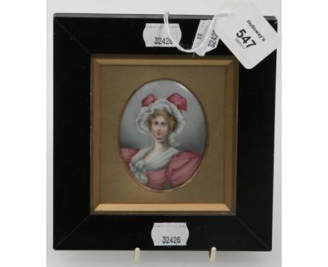 A late 19th century half length oil portrait miniature, on porcelain, of a young lady wearing a pink ribbon tied bonnet and g