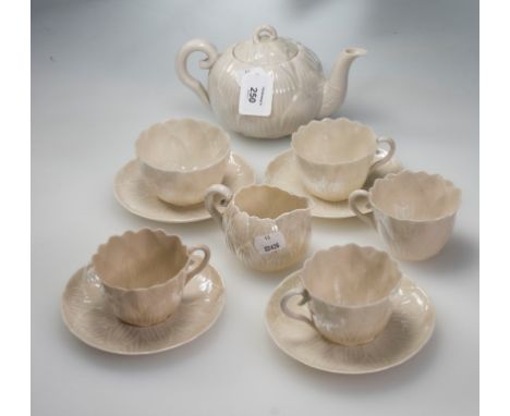 A Belleek porcelain leaf moulded tea service, comprising tea pot, cream, sugar, four cups and four saucers, First period blac