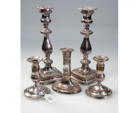 A pair of George IV Sheffield plate table candlesticks, of square section with removable drip pans, together with a pair of e