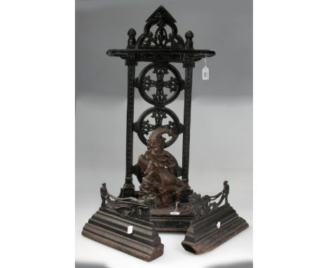 A Victorian cast iron gothic revival stick stand, a Mr Punch door porter and a pair of Burns andirons