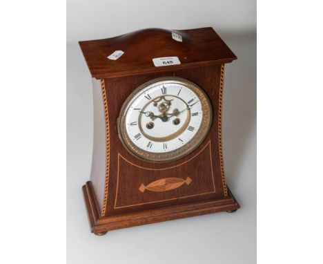 A late 19th century mahogany inlaid and strung mantel clock, the humped case enclosing an eight-day bell striking visible bro