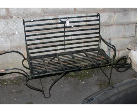 A contemporary wrought iron garden seat/planter display stand, fashioned as a wheelbarrow, 94 x 200cm