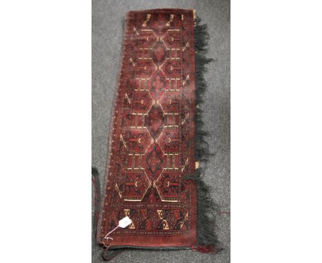 An old Tekke Turkoman piled woven trapping, with a diamond and arrow head ground, fringed on one face, 140cm long