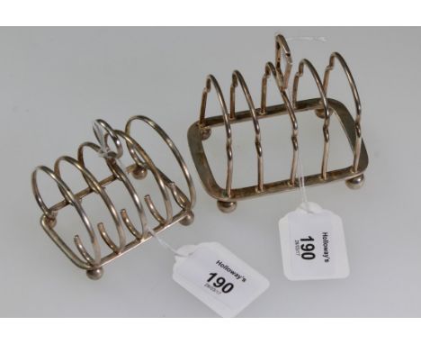 A 1920s silver melba toast rack, the scroll shaped wire work frame with four sections and loop handles, Birmingham 1925 by D.