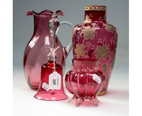 Nine pieces of Victorian and later cranberry glass, including table bell, wavy-rim jug, two enamel decorated vases and other 