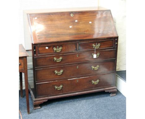 A George III mahogany fall front writing bureau, with fitted interior, the base with two short over three long drawers, raise
