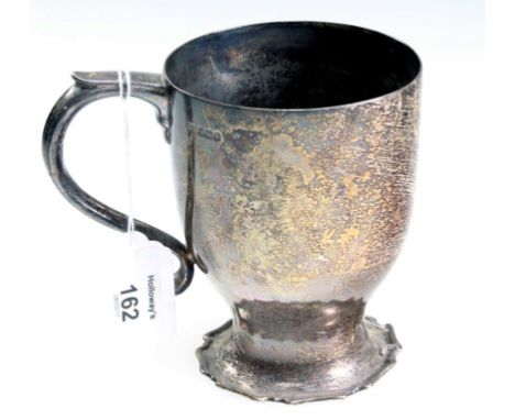 An Edwardian silver mug, of waisted form, with piecrust foot and shaped handle, Sheffield 1907, by Henry Atkin, 12cm high, 12