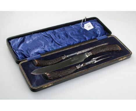 A late Edwardian silver mounted cased carving set, with natural antler handles, the silver marked for Sheffield 1910