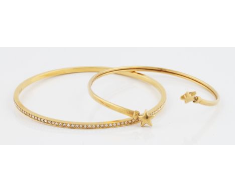 A 9ct yellow gold star design bangle, hallmarked Birmingham, weight approx. 2.8g, together with a Swarovski bangle, (2).